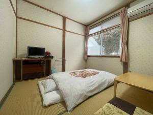 Postel nebo postele na pokoji v ubytování Refre Inn Fukuzawa