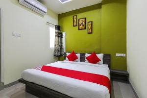 a bedroom with a large bed with red pillows at OYO Nabhyansh Elite in Indore