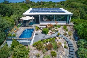 an overhead view of a house with a pool and solar panels at SALT Luxury Couples Villas in Venus Bay