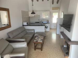 a living room with a couch and a table at Charming 3 bedroom villa located in Moraira. in Teulada