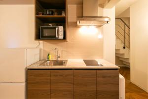 a small kitchen with a sink and a refrigerator at THE CONTRAIL Ebisu in Tokyo