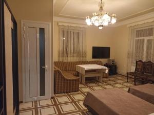 a living room with a couch and a table at Erazank Hotel in Gyumri