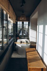 a bathroom with a tub and a large window at Great Exodus - Iasi City Center in Iaşi