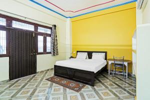 Cama ou camas em um quarto em OYO Hotel Madakini Destination