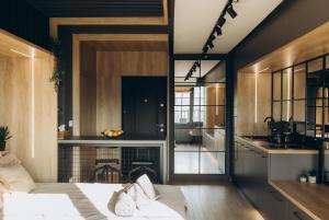 a living room with a bed and a kitchen at Exodus - Iasi City Center in Iaşi
