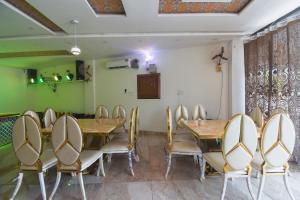ein Esszimmer mit einem Holztisch und Stühlen in der Unterkunft Hotel Shagun in Karnal
