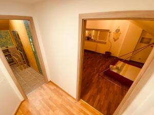 uma vista para um quarto com um corredor e uma escada em Pyramida & Sauna Relax Guest House em Zďár nad Sázavou