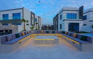 a rooftop patio with couches on a building at The Wave Villa - Fujairah in Fujairah