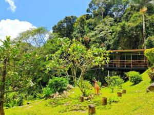 a woman standing in the grass in front of a building at J Residence in Kundasang