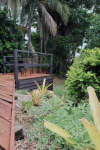 a wooden deck with a bench in a garden at UrbanNook - Heart of the city in Brisbane