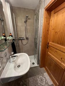 a bathroom with a sink and a shower at Chalet St. Lambertus in Lambertsberg