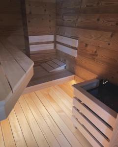 an empty sauna with wooden walls and wooden floors at Pohorje 11 in Hočko Pohorje