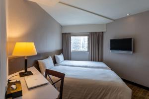 Postel nebo postele na pokoji v ubytování Guide Hotel Taipei Chongqing