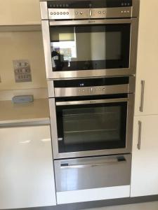 a stainless steel oven in a kitchen at Bright, modern & close to historic town in Bishops Waltham