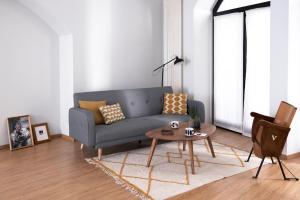 a living room with a blue couch and a table at ComeCasa Bright City Flat with Private Terrace in Milan
