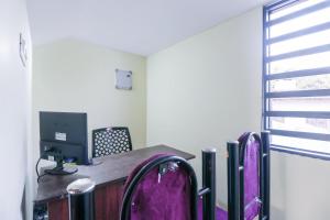 an office with a desk with a computer on it at Liberty Apartments in Chakkarakkal