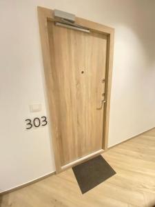 a wooden door in the corner of a room at Warm and light Loft near Vilnius centre in Vilnius