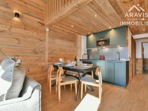 a kitchen and dining room with a table and chairs at Appartement Le Grand-Bornand, 3 pièces, 6 personnes - FR-1-391-182 in Le Grand-Bornand