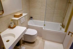 a bathroom with a toilet and a sink and a shower at Oakview in Colchester