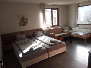 a living room with two beds and a couch at Dariya Guest House in Sapareva Banya