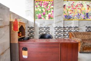 a desk in a room with paintings on the wall at OYO Hotel Grand City in Chandīgarh