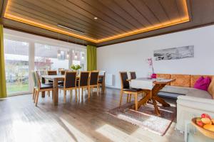 a dining room with a table and a couch at Holiday Home Hettlerhof in Maishofen