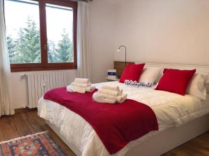 a bedroom with a large bed with towels on it at House Edelweiss by Holiday World in La Thuile