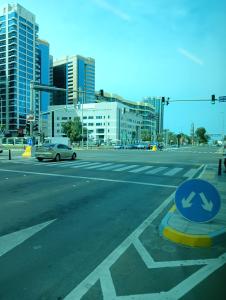 an empty city street with a car driving down the street at King Bed "STUDIO ROOM"-Khalidiya Abudhabi in Abu Dhabi