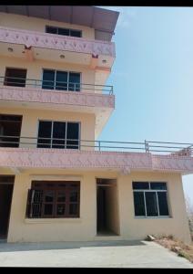 a house with a pink roof at Namobuddha Hotel n Lodge in Dhulikhel