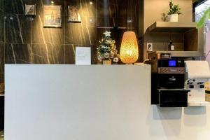 a white counter with a christmas tree behind it at Even Hotel in Gunsan-si
