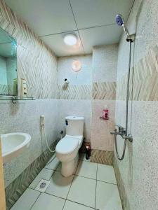 a bathroom with a toilet and a sink at King Bed "STUDIO ROOM"-Khalidiya Abudhabi in Abu Dhabi