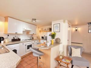 a kitchen with white cabinets and a counter top at 1 Bed in Tunbridge Wells 43355 