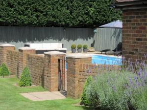 a brick retaining wall next to a swimming pool at 1 Bed in Tunbridge Wells 43355 