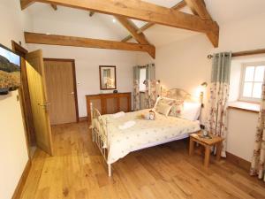 a bedroom with a bed and a wooden floor at 3 Bed in Northumberland National Park CN043 in Alwinton