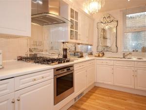 a kitchen with white cabinets and a stove top oven at 2 Bed in Harrogate HH073 in Harrogate