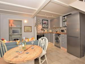a kitchen and living room with a wooden table and a dining room at 2 Bed in Dunstan CN031 in Craster