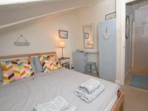 a bedroom with a large bed with towels on it at 2 Bed in Dunstan CN031 in Craster