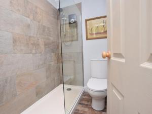 a bathroom with a toilet and a glass shower at 2 Bed in Dunstan CN031 in Craster