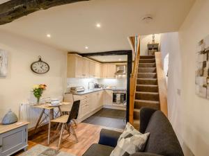a kitchen and a living room with a spiral staircase at 1 Bed in Bouth LCC78 in Bouth