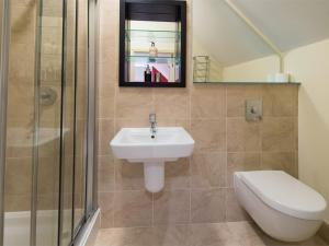 a bathroom with a sink and a toilet and a shower at 2 Bed in Ripon HH082 in Ripon