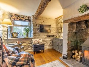 a living room with stone walls and a fireplace at 1 Bed in Bouth LCC40 in Bouth