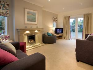 a living room with a fireplace and a tv at 2 Bed in Cartmel LCC47 in Cartmel