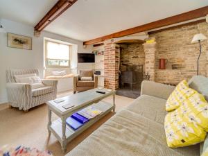 a living room with a couch and a table at 4 Bed in Isle of Purbeck IC177 in Corfe Castle