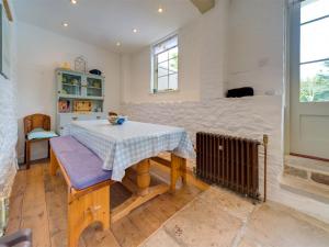a dining room with a table and a bed at 4 Bed in Isle of Purbeck IC177 in Corfe Castle