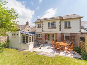 a house with a patio and a table and chairs at 4 Bed in Isle of Purbeck IC177 in Corfe Castle