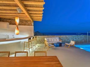 a villa with a swimming pool and a house at Beachfront Mykon Villa in Platis Gialos