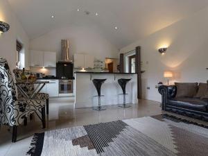 a living room with a couch and a kitchen at 1 Bed in Coniston LCC50 in Coniston