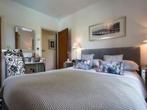 a bedroom with a large bed with pillows on it at 1 Bed in Coniston LCC50 in Coniston