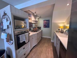 a large kitchen with white cabinets and a large appliance at 2 Bed in Pateley Bridge G0017 in Lofthouse