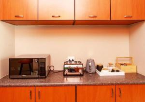 a kitchen counter with a microwave on a counter top at MorningSide Fortyfive in Ongwediva